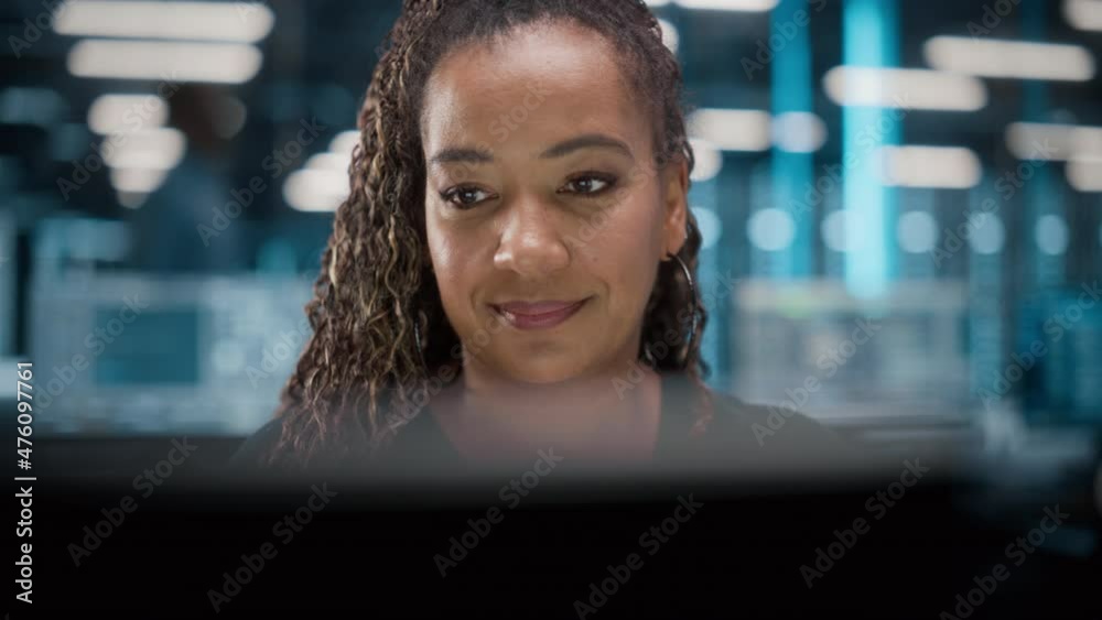 Poster portrait of african american female it specialist working on desktop in data center. system administ