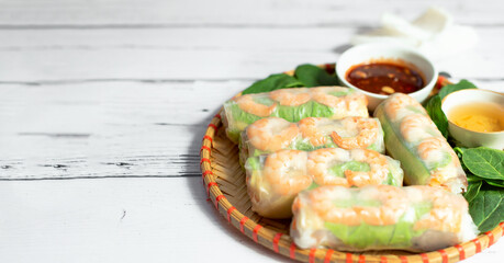 Vietnamese spring rolls with tender chicken, tiger prawns, rice noodles, juicy mango, fresh herbs...