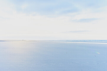 Calm sea panorama, in the distance the figure of a man
