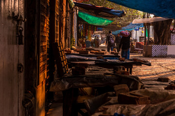 Landscape of a closed street market with people passing by Selective Focus