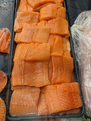 Sliced salmon portions for sale in a fish market