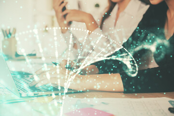 Double exposure of woman hands typing on computer and DNA hologram drawing. Medical education concept.