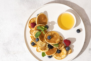 tasty pancakes and berries on white plate