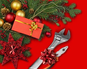 Christmas construction tools. A set of wrenches and fir branches on a desk.