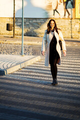 Obraz premium A girl walking through a pedestrian crossing