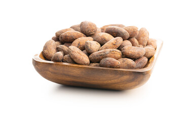Dried cocoa beans in wooden bowl