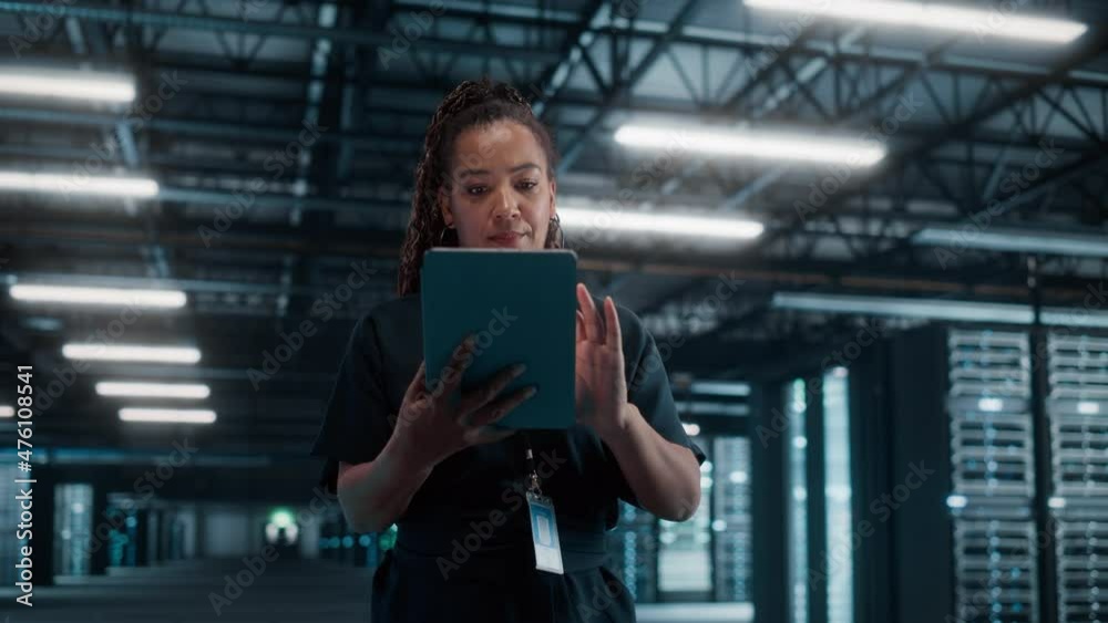 Aufkleber african american female it specialist using laptop computer, standing in big warehouse data center. 
