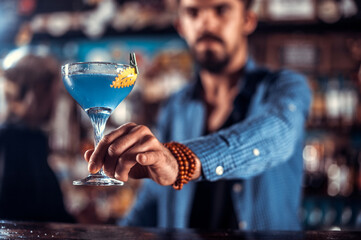 Focused barkeeper demonstrates his professional skills