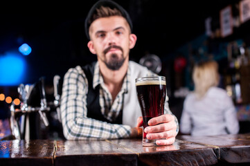 Expert mixologist is pouring a drink on the bar