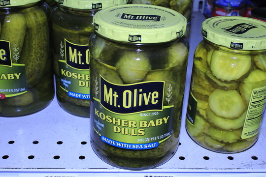 pickled cucumbers in jar MT Olive brand shot closeup on a metal shelf at a Dillons store in Hutchinson Kansas USA.