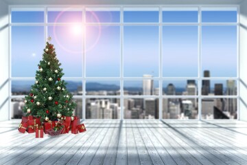 Christmas tree in modern office near big window and building view in city