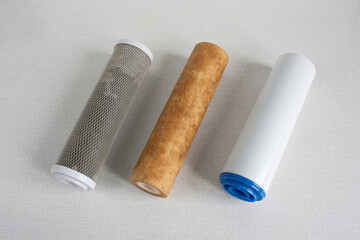 Used cartridges for water purification. Three cartridges for a household reverse osmosis system for water purification from mechanical impurities, chlorine and inorganic impurities.