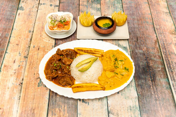 The most traditional flag has guatita, casserole, onion and rice in a single plate with chili and ripe banana with avocado and white rice