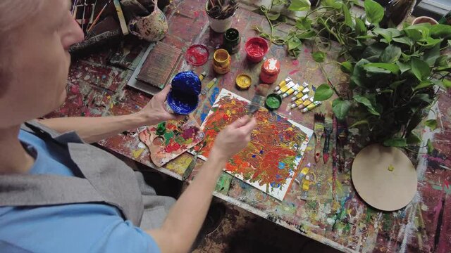 Painter in workspace creating modern art