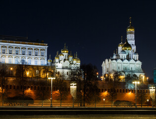 Moscow, Russia, Dec 09, 2021: Night view of Kremlevskaya embankment. The Kremlin: temples, bell tower, wall. Winter. December