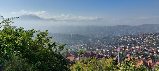 Panoramic shot of the city of Sarajevo surrounded by mountain forests in Bosnia and Herzegovina
