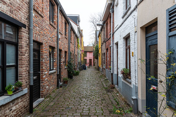 Fototapeta na wymiar Leuven, Flemish Brabant, Belgium - 12 18 2021: Deserted alley with traditional small houses