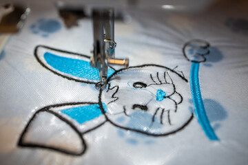 Machine embroidery of a rabbit on a cotton blanket. Rabbit design.