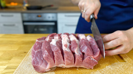 The cook makes cuts in a piece of meat. the process of cooking stuffed meat. Close up