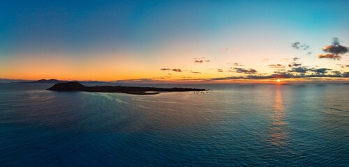 Fototapeta premium Beautiful panoramic view of the sunrise over Isla de Lobos island Corralejo Fuerteventura