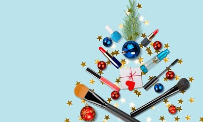 Christmas tree made of toys and cosmetics.Gift, balloons, snowflakes, lipstick, blush and makeup brushes.