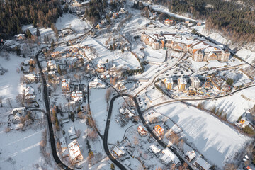 Winter city among the forest in the mountains. View of the winter landscape from a drone. Karpacz. Poland