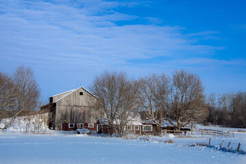 A winter countryside landscape with farm in the province of Quebec, Canada