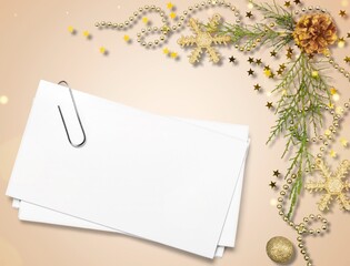 Christmas composition. Table with blank paper card mockup, gift boxes, fir tree branches, balls, garland.