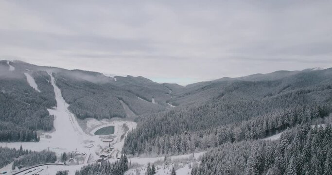 Tornik Ski Center, Zlatibor Mountain Resort. Serbia. Aerial View of White Winter Landscape, Snow Capped Hills and Pine Forest - Drone Shot
