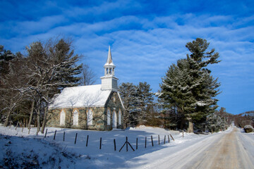 Winter landscape with the nice Frost Church. Magnificent little stone church