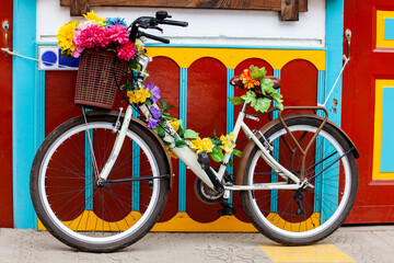 Decorated bicycle next to a colorful facade at the beautiful small town of Salento located at the region of Quindio in Colombia