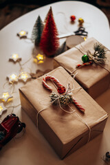 Christmas gifts lie on the table in festive packaging. Preparing and decorating the box