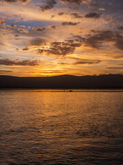 Fototapeta premium Golden sunset with dramatic sky clouds over Knysna lagoon