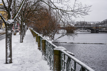 Snow on embankment in winter Prague