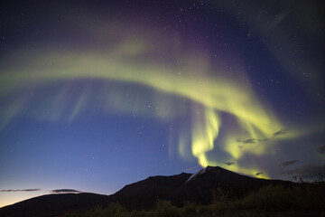 The aurora borealis (northern lights) in the sky over the mountains of the Brooks Range in the...