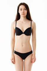 Fototapeta premium Model tests. Snap Models back view, Beautiful brunette woman in underwear, isolated on white.