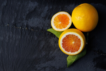 blood orange slices on dark slate background
