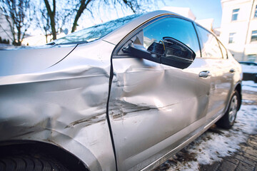 Car body side damage, traffic accident in winter season. Car door damage, broken and damaged side...