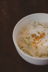 vertical white pasta bowl with creamy sauce