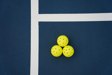 Close up of a pickleball on pickleball court.