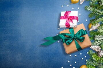 Merry Christmas and Happy New Year greeting card design with gift boxes decorated, tree branches with balls.