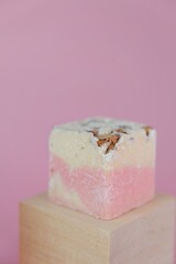 Flower Bath Bombs with rose extract on wooden blocks .