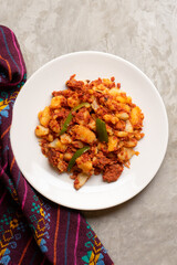 Potatoes with chorizo on a gray background.  Mexican food