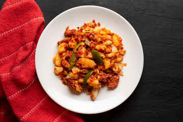 Potatoes with chorizo on a dark background.  Mexican food