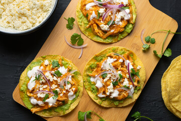 Chicken tinga tostadas with cheese and avocado. Mexican food
