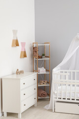 Fototapeta na wymiar Stylish interior of modern children's room with baby crib