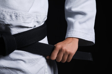 Female karate instructor on dark background, closeup © Pixel-Shot