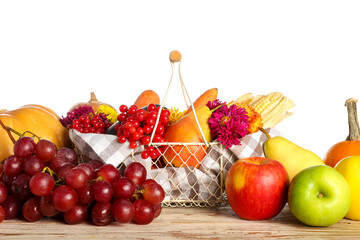 Basket with different healthy food on table against white background. Harvest festival