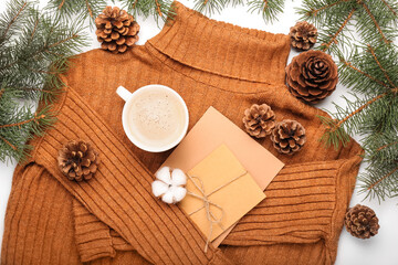 Composition with sweater, cards, cup of cacao, cones and fir branches on white background, closeup