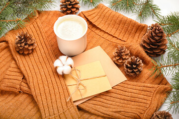 Composition with sweater, cards, cup of cacao, cones and fir branches on white background, closeup